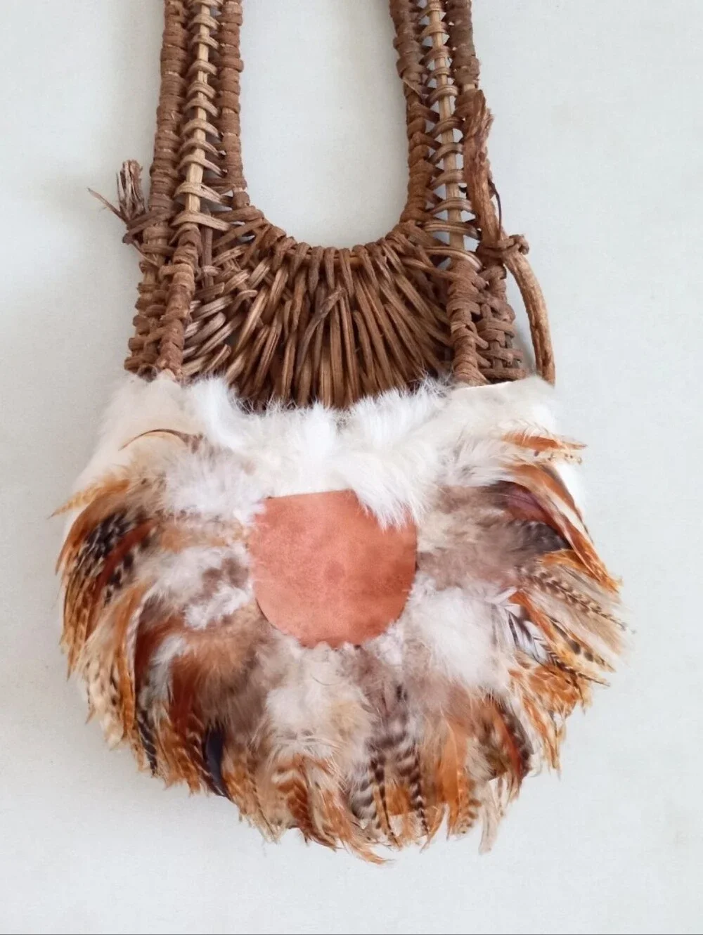 Indigenous Native American vintage natural wicker and feather wall basket